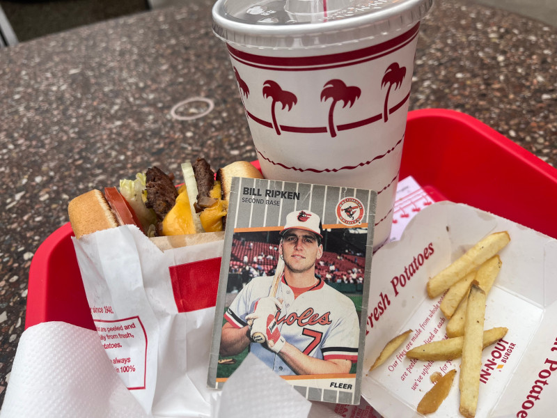 [Image: Billy Ripken card sitting in the middle of a tray containing a Double Double burger and a mostly empty tray of fries.]