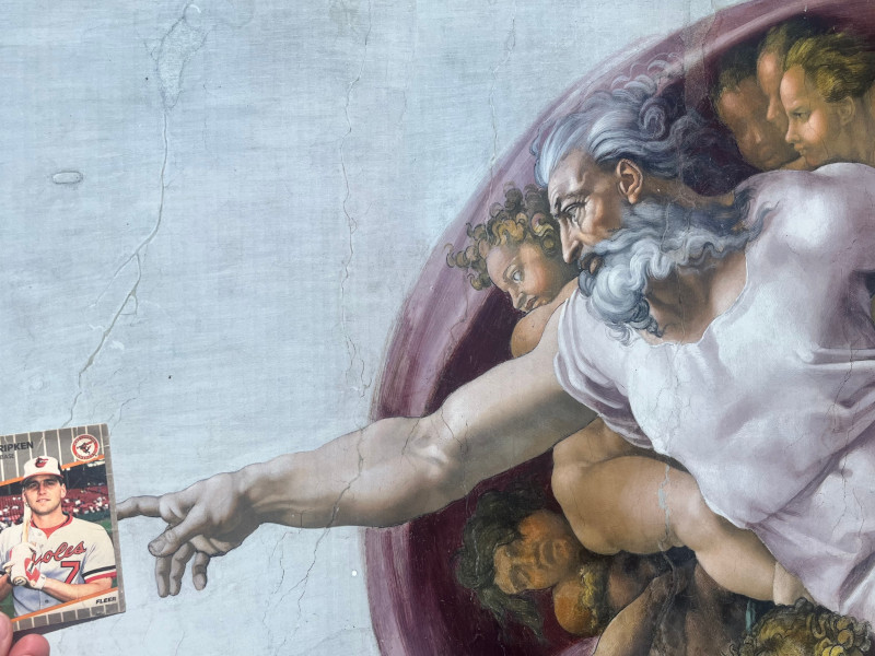 [Image: The 1989 Fleer Billy Ripken error card positioned in front of Michelangelo's Creation of Adam in such a way that God's finger is touching the obscenity on Ripken's bat."]