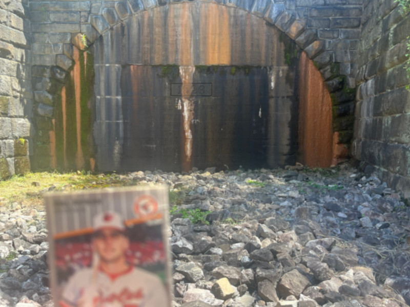 [Image: Billy Ripken card at the western terminus of the Church Hill railroad tunnel. This end is sealed to prevent access and is constantly leaking groundwater that has flooded the collapsed tunnel bore.]