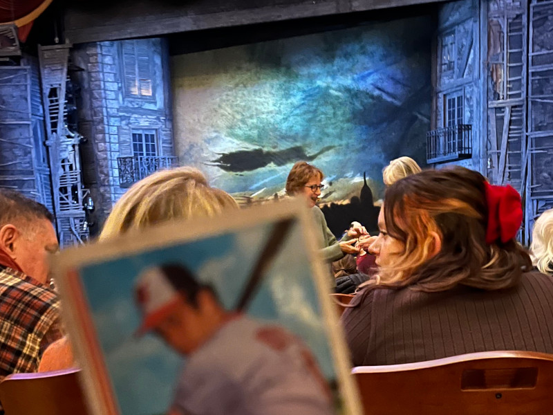 [Image: Cal Ripken rookie card in front of the set during the intermission of a stage performance of Les Miserables.]