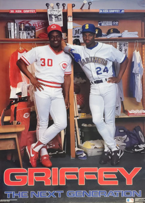 Image: Poster titled "Griffey The Next Generation." Ken Griffey, Sr. is pictured in his Cincinnati Reds uniform standing next to Ken Griffey, Jr. in a Mariners uniform. Both are posed in front of the younger Griffey's locker.