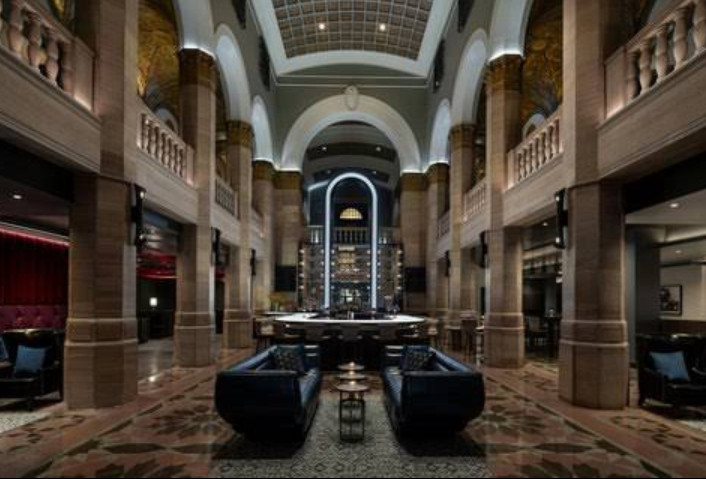Image: The ornate, dramatically lit stone lobby of The Midland.